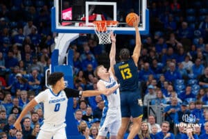 Creighton's Josh Dix defends the basket against Marquette's Royce Parham. Creighton men's basketball hosts Marquette at CHI Health Center on Saturday, Dec 20, 2025, in Omaha, Nebraska. Photo by Kyle Byers.