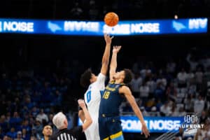 Creighton's Jasen Green faces off against Marquette's Caedin Hamilton for tipoff. Creighton men's basketball hosts Marquette at CHI Health Center on Saturday, Dec 20, 2025, in Omaha, Nebraska. Photo by Kyle Byers.