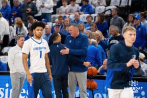 Creighton head coach Greg McDermott meets with Marquette head coach Shaka Smart for a pregame handshake. Creighton men's basketball hosts Marquette at CHI Health Center on Saturday, Dec 20, 2025, in Omaha, Nebraska. Photo by Kyle Byers.