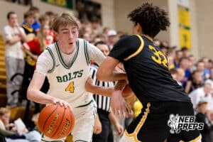 Lincoln Pius X guard Zach Taubenhein (4) tries to move past defender Drayke Brown (32) during a high school basketball game Thursday, December 11, 2025, in Lincoln, Nebraska. Photo by Braden Cochran.