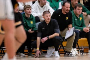 Lincoln Pius X head coach Adam Brill watches his team during a play during a high school basketball game Thursday, December 11, 2025, in Lincoln, Nebraska. Photo by Braden Cochran.