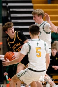 Gretna East ball carrier Lucas Winterboer (30) is swarmed by a pair of defenders during a high school basketball game Thursday, December 11, 2025, in Lincoln, Nebraska. Photo by Braden Cochran.