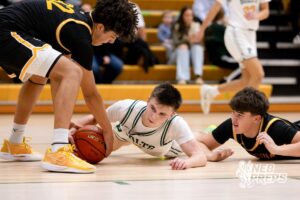 A Pius X player contests a loose ball during a high school basketball game Thursday, December 11, 2025, in Lincoln, Nebraska. Photo by Braden Cochran.