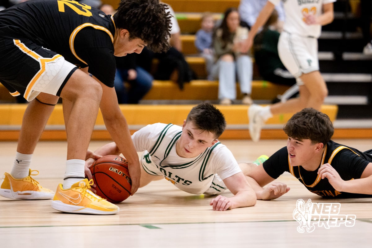 A Pius X player contests a loose ball during a high school basketball game Thursday, December 11, 2025, in Lincoln, Nebraska. Photo by Braden Cochran.