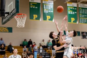 A Lincoln Pius X attacker is defneded by Greta East denfender Lucas Winterboer (30) during a high school basketball game Thursday, December 11, 2025, in Lincoln, Nebraska. Photo by Braden Cochran.