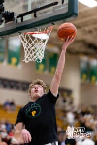 A Pius X player reaches for a lay up in warmups before a high school basketball game against Gretna East on Thursday, December 11, 2025, in Lincoln, Nebraska. Photo by Braden Cochran.