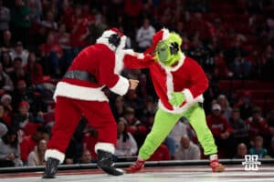 Santa Claus and The Grinch wrestles against each other during a college wrestling duel on Friday, Dec 19, 2025, in Lincoln, Nebraska.