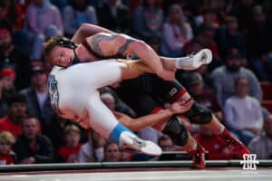 Nebraska Cornhusker Camden McDanel lunges North Carolina Tar Heel Robert Platt during a college wrestling duel on Friday, Dec 19, 2025, in Lincoln, Nebraska.