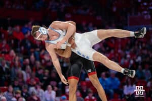 Nebraska Cornhusker Christopher Minto lifts North Carolina Tar Heel Collin Carrigan during a college wrestling duel at 174 on Friday, Dec 19, 2025, in Lincoln, Nebraska.
