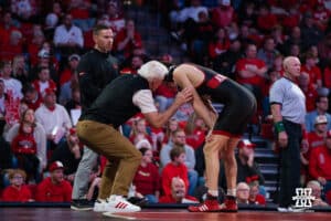 Nebraska Cornhusker head coach Mark Manning talks LJ Araujo during a college wrestling duel on Friday, Dec 19, 2025, in Lincoln, Nebraska.