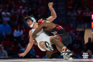 Nebraska Cornhusker Antrell Taylor takes down North Carolina Tar Heel Laird Root during a college wrestling duel at 157 on Friday, Dec 19, 2025, in Lincoln, Nebraska.