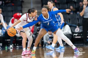 Creighton Bluejay Kendall McGee (1) attempts to steal the ball from Omaha Maverick Sarai Estupiñan (5) during a basketball game against Omaha on Wednesday, Dec 17, 2025, in Omaha, Nebraska. Photo by Brandon Tiedemann.