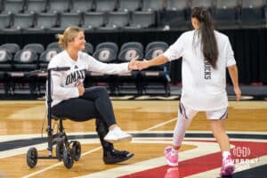 Omaha Maverick Cora Olsen (22) high fives a teammate before a basketball game against Creighton on Wednesday, Dec 17, 2025, in Omaha, Nebraska. Photo by Brandon Tiedemann.