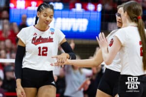 Nebraska Cornhusker outside hitter Taylor Landfair (12) gives Rebekah Allick five against the Texas A&M Aggies in the fifth set during the NCAA Volleyball Regional on Sunday, Dec. 14, 2025, in Lincoln, Nebraska. Photo by John S. Peterson.