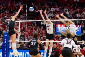 Nebraska Cornhusker setter Bergen Reilly (2) and middle blocker Rebekah Allick (5) jump up to block Texas A&M Aggie outside hitter Emily Hellmuth (4) in the fourth set during the NCAA Volleyball Regional on Sunday, Dec. 14, 2025, in Lincoln, Nebraska. Photo by John S. Peterson.