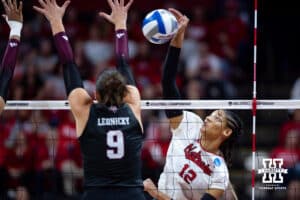 Nebraska Cornhusker outside hitter Taylor Landfair (12) spikes the ball against Texas A&M Aggie opposite Logan Lednicky (9) in the second set during the NCAA Volleyball Regional on Sunday, Dec. 14, 2025, in Lincoln, Nebraska. Photo by John S. Peterson.