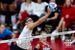 Nebraska Cornhusker middle blocker Rebekah Allick (5) tips the ball over the net against the Texas A&M Aggies in the first set during the NCAA Volleyball Regional on Sunday, Dec. 14, 2025, in Lincoln, Nebraska. Photo by John S. Peterson.