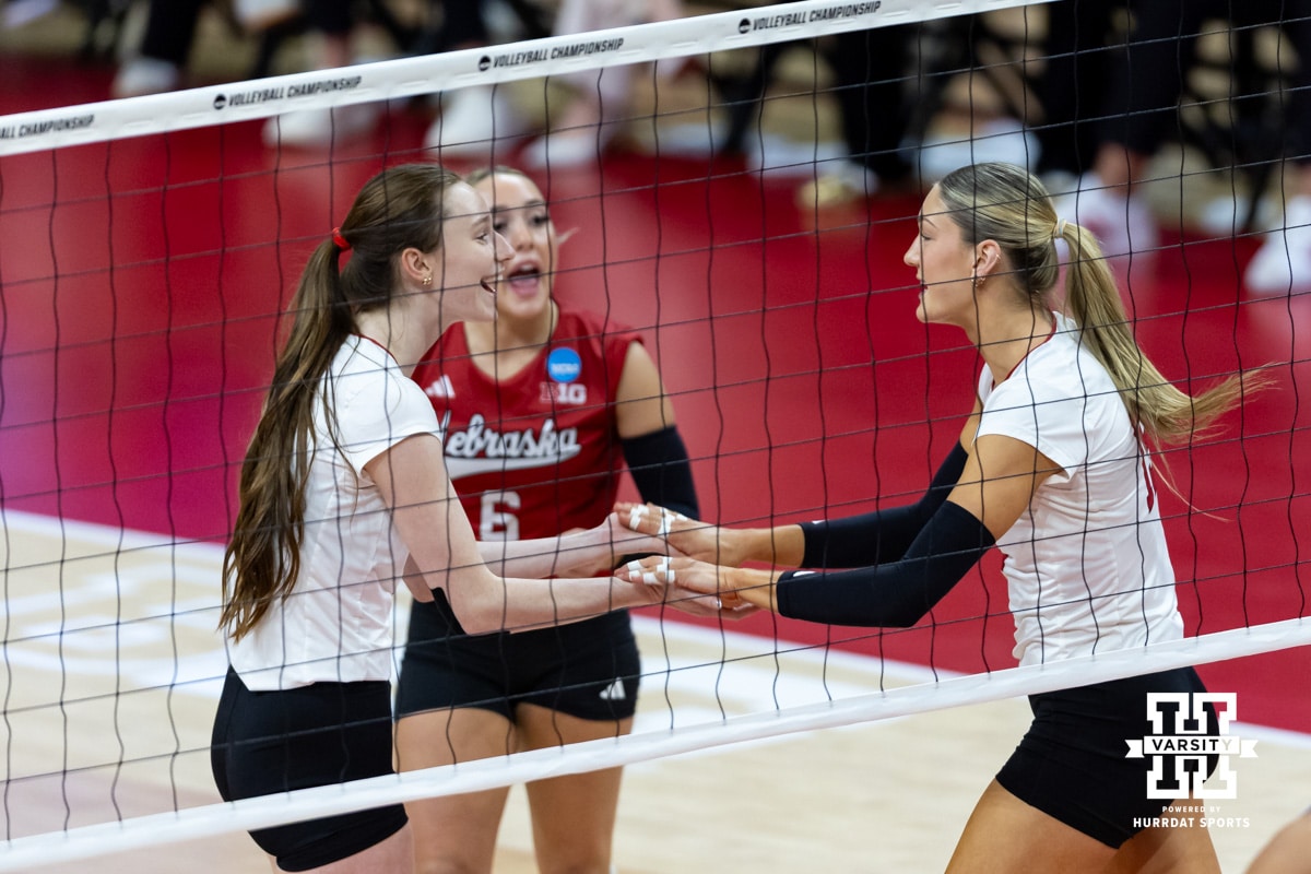 Nebraska Cornhusker middle blocker Andi Jackson (15) gives Bergen Reilly five after a kill against the Kansas Jayhawks in the third set during the NCAA volleyball championship sweet sixteen match on Friday, Dec. 12, 2025, in Lincoln, Nebraska. Photo by John S. Peterson.
