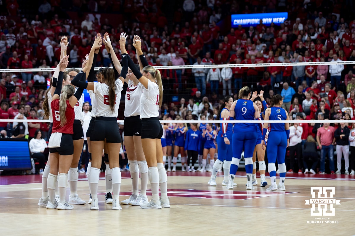 Nebraska Cornhuskers huddle up before the first serve against the Kansas Jayhawks during the NCAA volleyball championship sweet sixteen match on Friday, Dec. 12, 2025, in Lincoln, Nebraska. Photo by John S. Peterson.