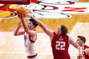 Nebraska Cornhusker forward Pryce Sandfort (21) makes a lay up against Wisconsin Badger forward Austin Rapp (22) in the second half during a college men’s basketball game on Wednesday, Dec. 10, 2025, in Lincoln, Nebraska. Photo by John S. Peterson.