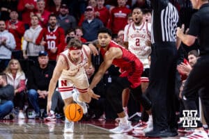 Wisconsin Badger guard Nick Boyd (2) standing out of bounds going after the ball against Nebraska Cornhusker guard Sam Hoiberg (1) in the first half during a college men’s basketball game on Wednesday, Dec. 10, 2025, in Lincoln, Nebraska. Photo by John S. Peterson.