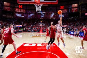 Nebraska Cornhusker guard Sam Hoiberg (1) drives to the basket for a lay up against Wisconsin Badger guard Nick Boyd (2) in the first half during a college men’s basketball game on Wednesday, Dec. 10, 2025, in Lincoln, Nebraska. Photo by John S. Peterson.