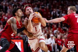 Nebraska Cornhusker guard Sam Hoiberg (1) drives to the basket against Wisconsin Badger guard Nick Boyd (2) and guard Andrew Rohde (7) in the first half during a college men’s basketball game on Wednesday, Dec. 10, 2025, in Lincoln, Nebraska. Photo by John S. Peterson.