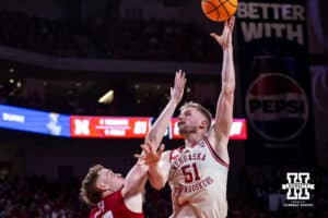 Nebraska Cornhusker forward Rienk Mast (51) makes a basket against Wisconsin Badger forward Austin Rapp (22) in the first half during a college men’s basketball game on Wednesday, Dec. 10, 2025, in Lincoln, Nebraska. Photo by John S. Peterson.