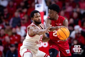 Nebraska Cornhusker forward Jared Garcia (15) reaches for the ball against Wisconsin Badger guard John Blackwell (25) in the first half during a college men’s basketball game on Wednesday, Dec. 10, 2025, in Lincoln, Nebraska. Photo by John S. Peterson.