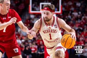 Nebraska Cornhusker guard Sam Hoiberg (1) dribbles the ball against Wisconsin Badger guard Andrew Rohde (7) in the first half during a college men’s basketball game on Wednesday, Dec. 10, 2025, in Lincoln, Nebraska. Photo by John S. Peterson.