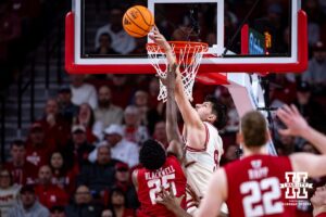 Nebraska Cornhusker forward Berke Buyuktuncel (9) blocks a shot from Wisconsin Badger guard John Blackwell (25) in the first half during a college men’s basketball game on Wednesday, Dec. 10, 2025, in Lincoln, Nebraska. Photo by John S. Peterson.