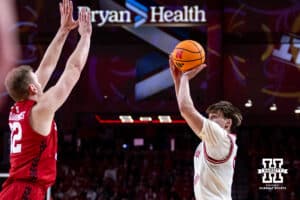 Nebraska Cornhusker forward Braden Frager (5) makes a three point shot against Wisconsin Badger forward Aleksas Bieliauskas (32) in the first half during a college men’s basketball game on Wednesday, Dec. 10, 2025, in Lincoln, Nebraska. Photo by John S. Peterson.