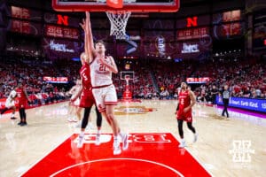 Nebraska Cornhusker forward Pryce Sandfort (21) makes a lay up against Wisconsin Badger guard Jack Janicki (5) in the first half during a college men’s basketball game on Wednesday, Dec. 10, 2025, in Lincoln, Nebraska. Photo by John S. Peterson.