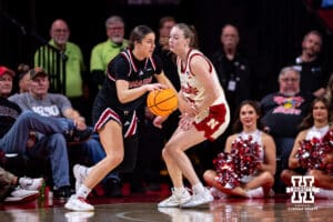 Omaha Maverick guard Regan Juenemann (24) drives to the basket against Nebraska Cornhusker guard Claire Johnson (5) during a college women’s basketball game on Tuesday, Dec. 9, 2025, in Lincoln, Nebraska. Photo by John S. Peterson.