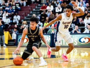 Lincoln Southeast guard Jayvis Johnson (5) cuts back with the ball pursued by Lincoln North Star’s J'Shawn Afuh (10) during a high school basketball game on Friday, December 5, 2025, in Lincoln, Nebraska. Photo by Braden Cochran.