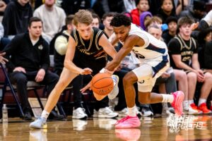 Lincoln Southeast’s Carter Chatelain (2) dives for a loose ball against Lincoln North Star Kei Kuon (20) during a high school basketball game on Friday, December 5, 2025, in Lincoln, Nebraska. Photo by Braden Cochran.