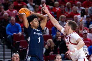 Creighton Bluejay guard Austin Swartz (1) keeps the ball away from Nebraska Cornhusker guard Cale Jacobsen (31) in the second half during a college basketball game on Sunday, Dec. 7, 2025, in Lincoln, Nebraska. Photo by John S. Peterson.