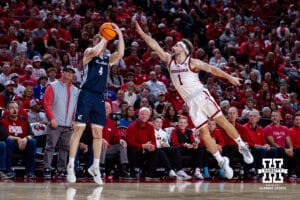 Creighton Bluejay guard Josh Dix (4) makes a three-point shot against Nebraska Cornhusker guard Sam Hoiberg (1) in the second half during a college basketball game on Sunday, Dec. 7, 2025, in Lincoln, Nebraska. Photo by John S. Peterson.