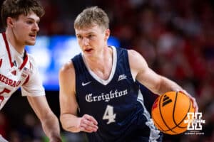 Creighton Bluejay guard Josh Dix (4) dribbles the ball against Nebraska Cornhusker forward Braden Frager (5) in the second half during a college basketball game on Sunday, Dec. 7, 2025, in Lincoln, Nebraska. Photo by John S. Peterson.
