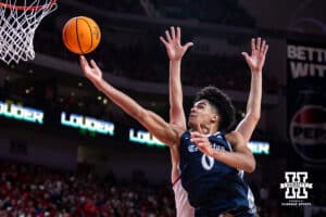 Creighton Bluejay forward Jasen Green (0) makes a lay up against Nebraska Cornhusker forward Berke Buyuktuncel (9) in the second half during a college basketball game on Sunday, Dec. 7, 2025, in Lincoln, Nebraska. Photo by John S. Peterson.