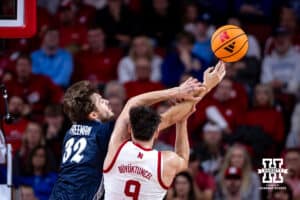 Creighton Bluejay forward Owen Freeman (32) and Nebraska Cornhusker forward Berke Buyuktuncel (9) reach for the rebound in the first half during a college basketball game on Sunday, Dec. 7, 2025, in Lincoln, Nebraska. Photo by John S. Peterson.