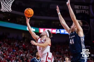 Nebraska Cornhusker guard Sam Hoiberg (1) drives to the basket for a lay up against Creighton Bluejay forward Isaac Traudt (41) in the first half during a college basketball game on Sunday, Dec. 7, 2025, in Lincoln, Nebraska. Photo by John S. Peterson.