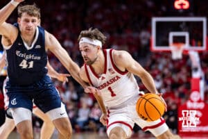 Nebraska Cornhusker guard Sam Hoiberg (1) drives to the basket against Creighton Bluejay forward Isaac Traudt (41) in the first half during a college basketball game on Sunday, Dec. 7, 2025, in Lincoln, Nebraska. Photo by John S. Peterson.