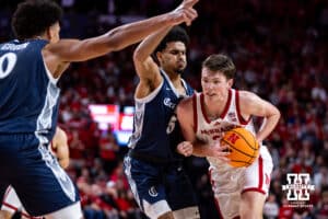Nebraska Cornhusker forward Pryce Sandfort (21) drives to the lane against Creighton Bluejay guard Nik Graves (5) in the first half during a college basketball game on Sunday, Dec. 7, 2025, in Lincoln, Nebraska. Photo by John S. Peterson.