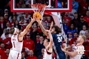Nebraska Cornhusker guard Sam Hoiberg (1) and Creighton Bluejay forward Owen Freeman (32) reach for the rebound in the first half during a college basketball game on Sunday, Dec. 7, 2025, in Lincoln, Nebraska. Photo by John S. Peterson.