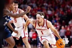 Nebraska Cornhusker guard Sam Hoiberg (1) dribbles the ball against Creighton Bluejay guard Blake Harper (2) in the first half during a college basketball game on Sunday, Dec. 7, 2025, in Lincoln, Nebraska. Photo by John S. Peterson.