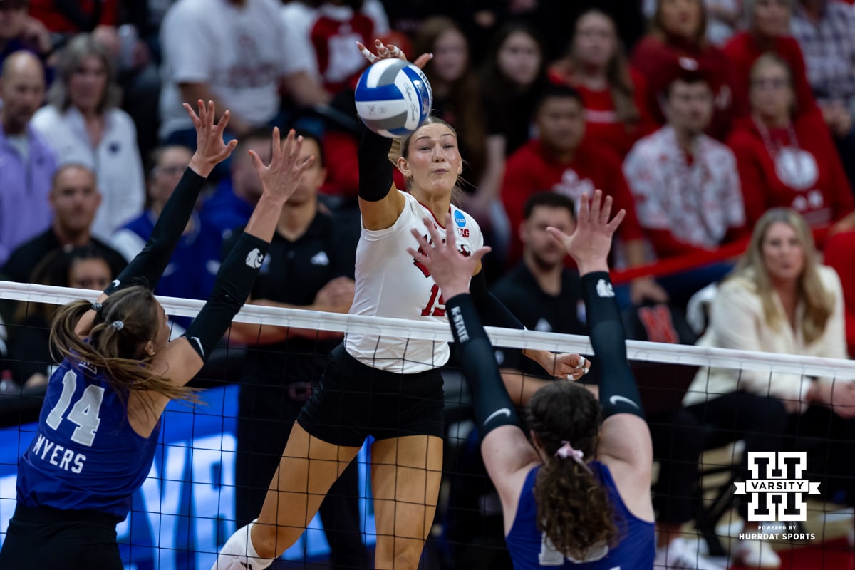 Nebraska Cornhusker middle blocker Andi Jackson (15) spikes the ball against Kansas State Wildcat outside hitter Shaylee Myers (14) and middle blocker Brenna Schmidt (18) in the second set during the second round of the NCAA volleyball tournament on Saturday, Dec. 6, 2025, in Lincoln, Nebraska. Photo by John S. Peterson.