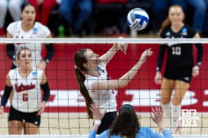 Nebraska Cornhusker setter Bergen Reilly (2) dumps the ball against LIU Shark outside hitter Bella Correia (13) in the third set during the first round of the NCAA volleyball tournament on Friday, Dec. 5, 2025, in Lincoln, Nebraska. Photo by John S. Peterson.