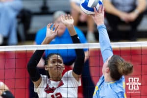 Nebraska Cornhusker outside hitter Taylor Landfair (12) jumps up to block LIU Sharks during the first round of the NCAA volleyball tournament on Friday, Dec. 5, 2025, in Lincoln, Nebraska. Photo by John S. Peterson.