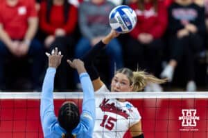 Nebraska Cornhusker middle blocker Andi Jackson (15) spikes the ball against LIU Shark middle blocker Yasmeen Muhammad (15) during the first round of the NCAA volleyball tournament on Friday, Dec. 5, 2025, in Lincoln, Nebraska. Photo by John S. Peterson.